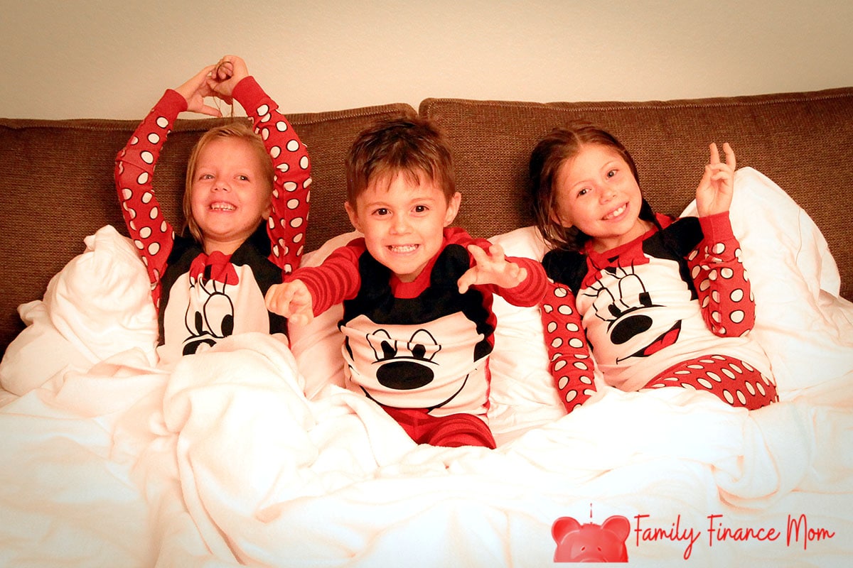Three kids at Disney World resort in Mickey and Minnie pajamas